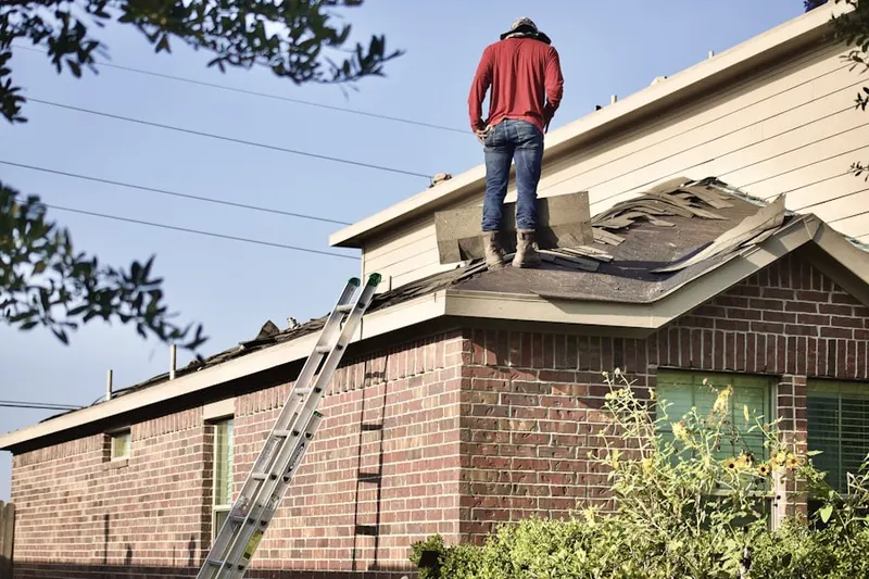 Professional roofer working on a residential roof in Garnet Oaks